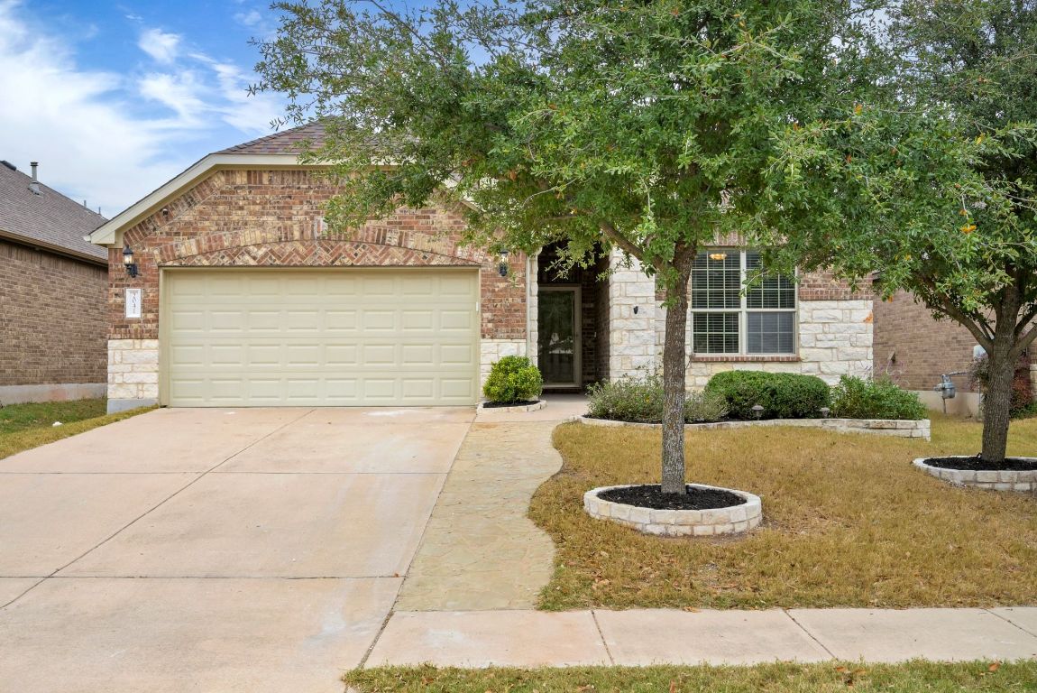 2041 Elaina Loop Leander, TX 78641 - Photo 6 of 25 An added stone path alongside the driveway widens the driveway, adding extra space and a welcoming touch on your way to the front door.