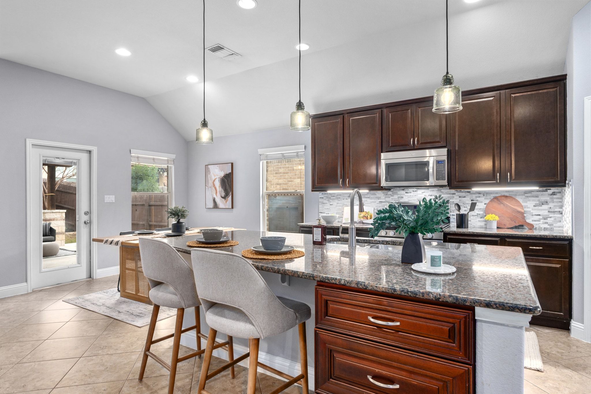 2041 Elaina Loop Leander, TX 78641 - Photo 9 of 25 a kitchen with sink a microwave and wooden cabinets