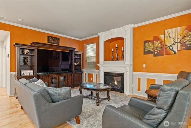 a living room with fireplace furniture and a flat screen tv