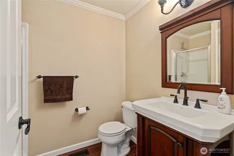 a bathroom with a toilet sink and mirror