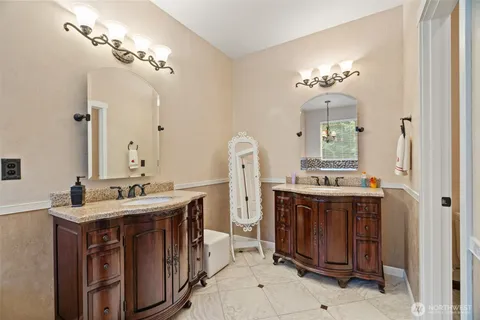 a spacious bathroom with a double vanity sink and a mirror