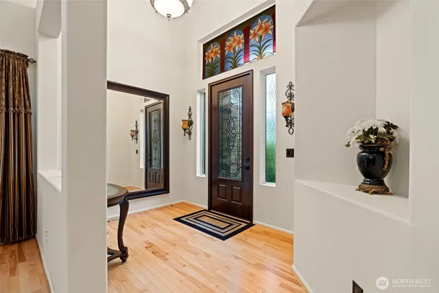 a view of a hallway with wooden floor and living room