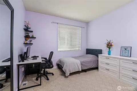 a bedroom with a bed and a desk