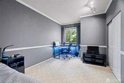 a bedroom with a bed and a tv