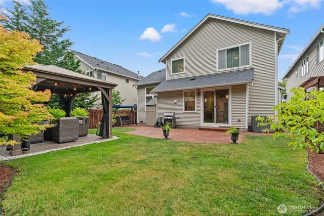 a view of a house with a yard and sitting area