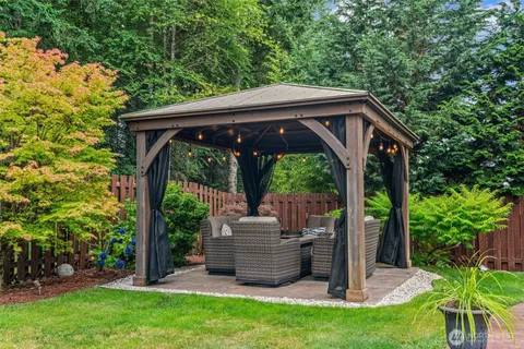 a view of backyard with deck and garden