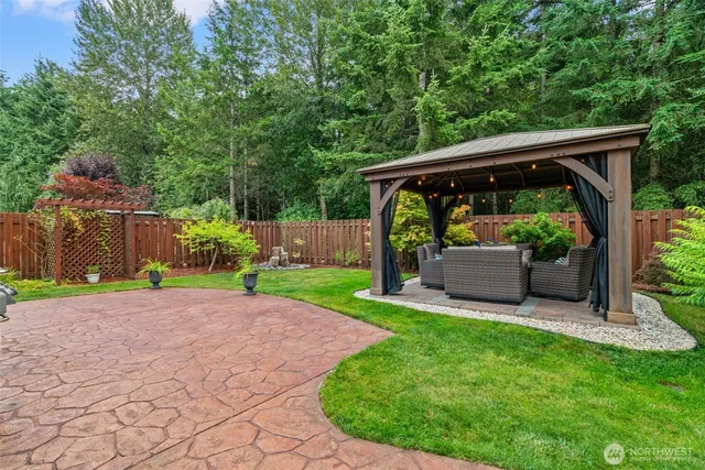 a view of a patio with furniture and a garden