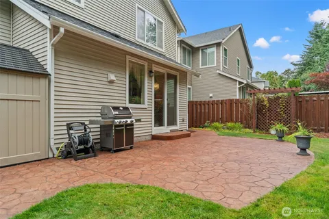 a view of a backyard with furniture and a fence