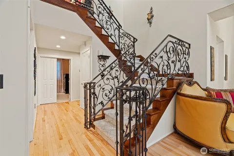 a view of entryway and hall with wooden floor