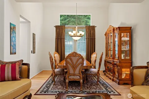 a living room with furniture a lamp and large window
