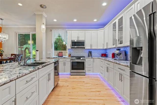 a kitchen with granite countertop a stove top oven sink and cabinets