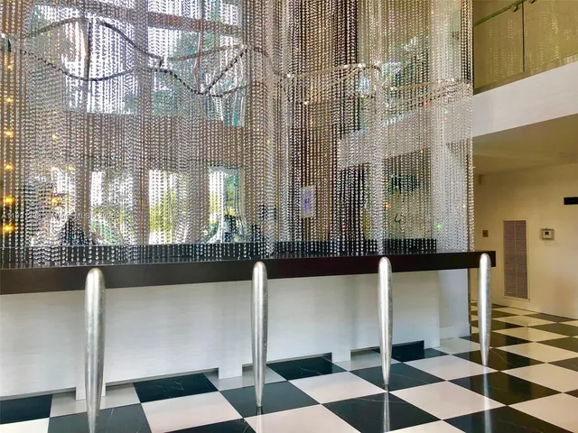 a living room with fireplace furniture and a large window