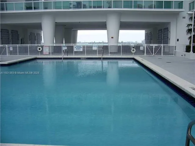 a view of pool table and chairs in front of house