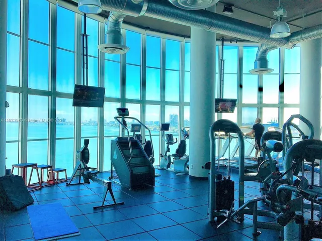 a room with lots of windows and tables