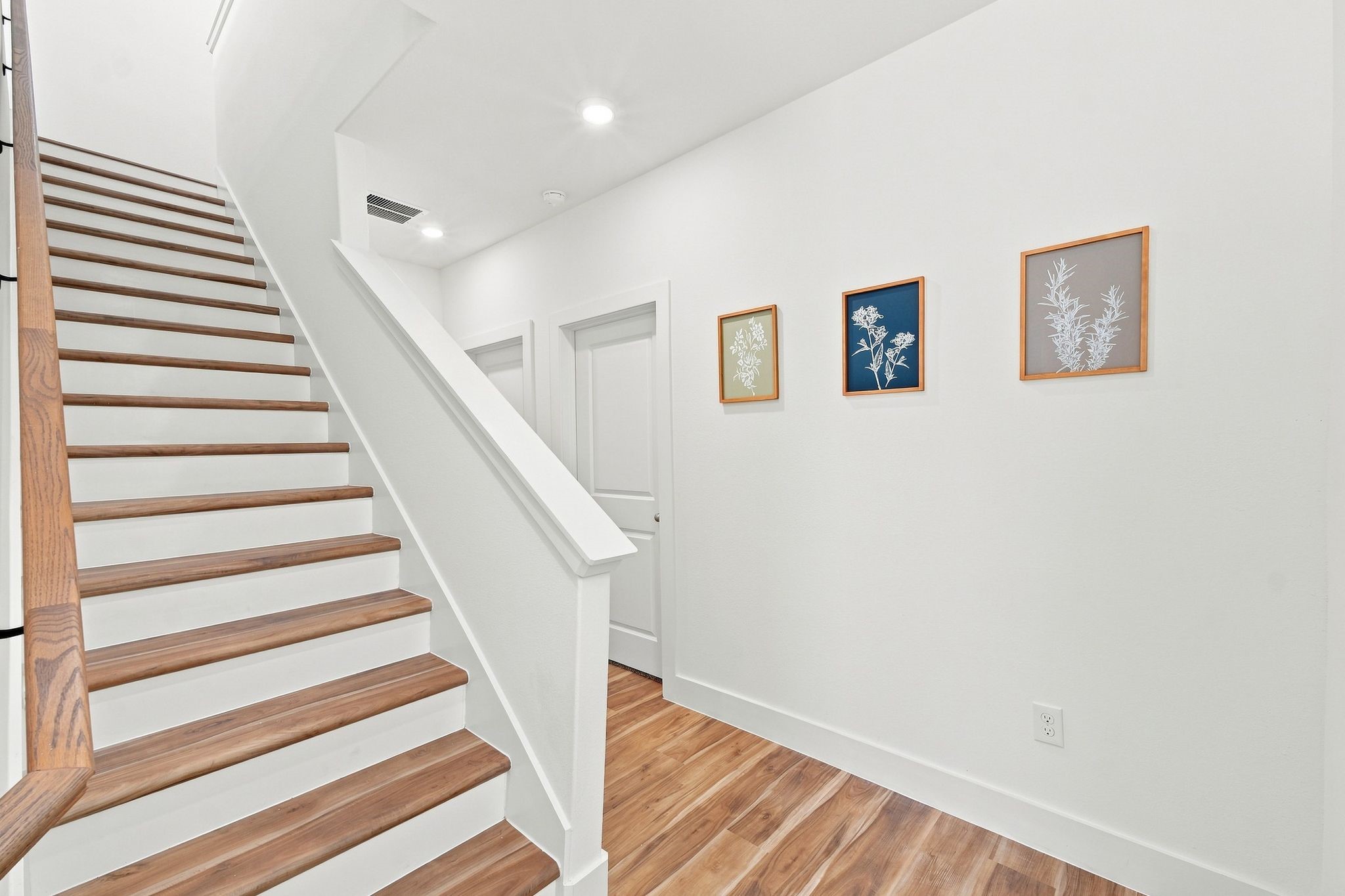 6057 Cebra Street Houston, TX 77091 - Photo 14 of 42 Beautiful wood staircase with modern railing details and a bright, contemporary design. Photos are from a different property with a similar floor plan. Finishes, features, and orientation may vary.