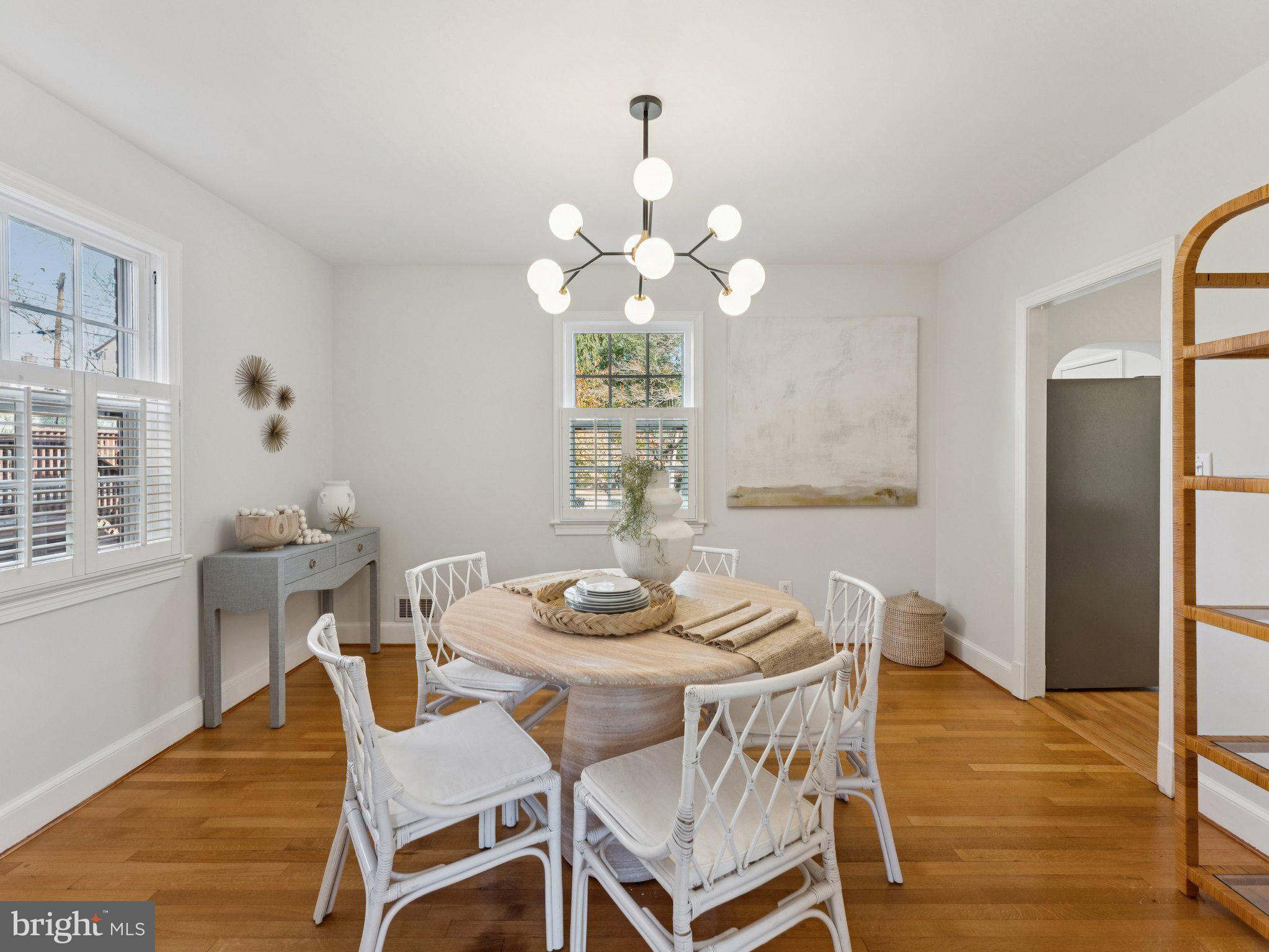 4821 45th Street Northwest Washington, DC 20016 - Photo 11 of 38 a dining room with furniture a chandelier and wooden floor