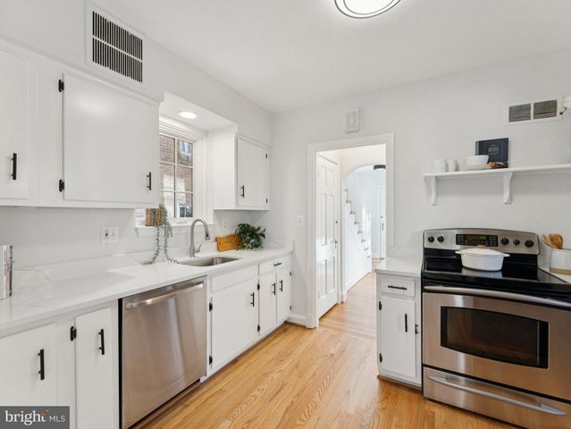 a kitchen with a sink stove and cabinets