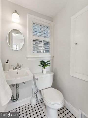 a bathroom with a toilet a sink and a mirror