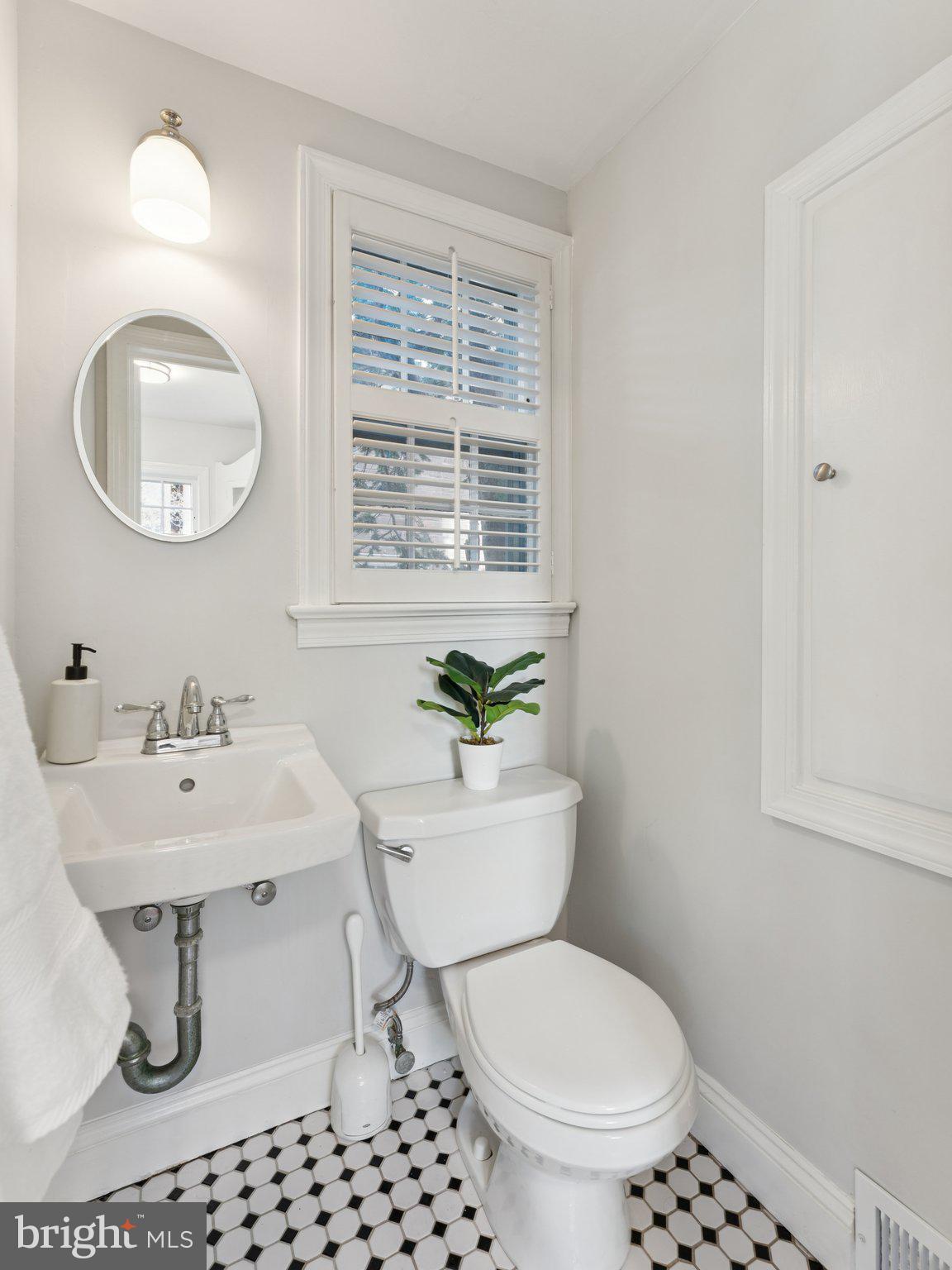 4821 45th Street Northwest Washington, DC 20016 - Photo 18 of 38 a bathroom with a toilet a sink and a mirror