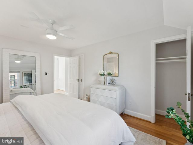 a spacious bedroom with a bed and a dresser