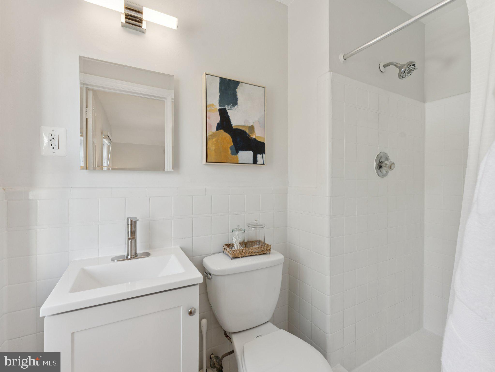 4821 45th Street Northwest Washington, DC 20016 - Photo 22 of 38 a bathroom with a toilet sink and mirror