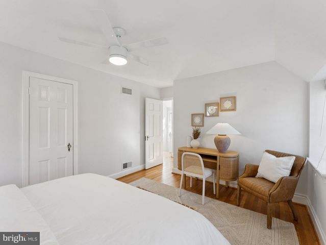 a bedroom with a bed and chair