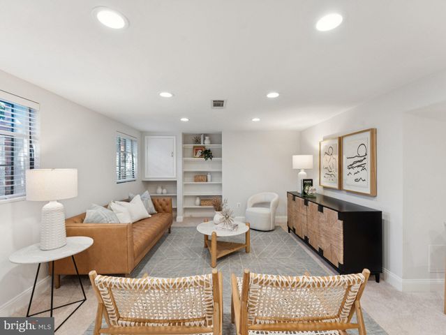 a living room with furniture a rug and a table