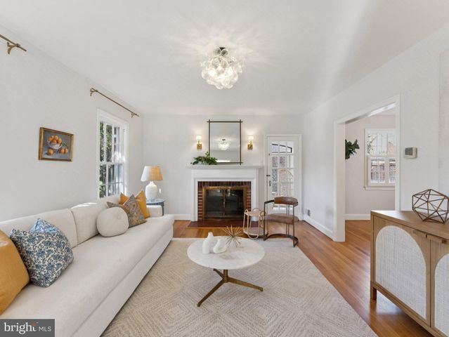 a living room with furniture a fireplace and window