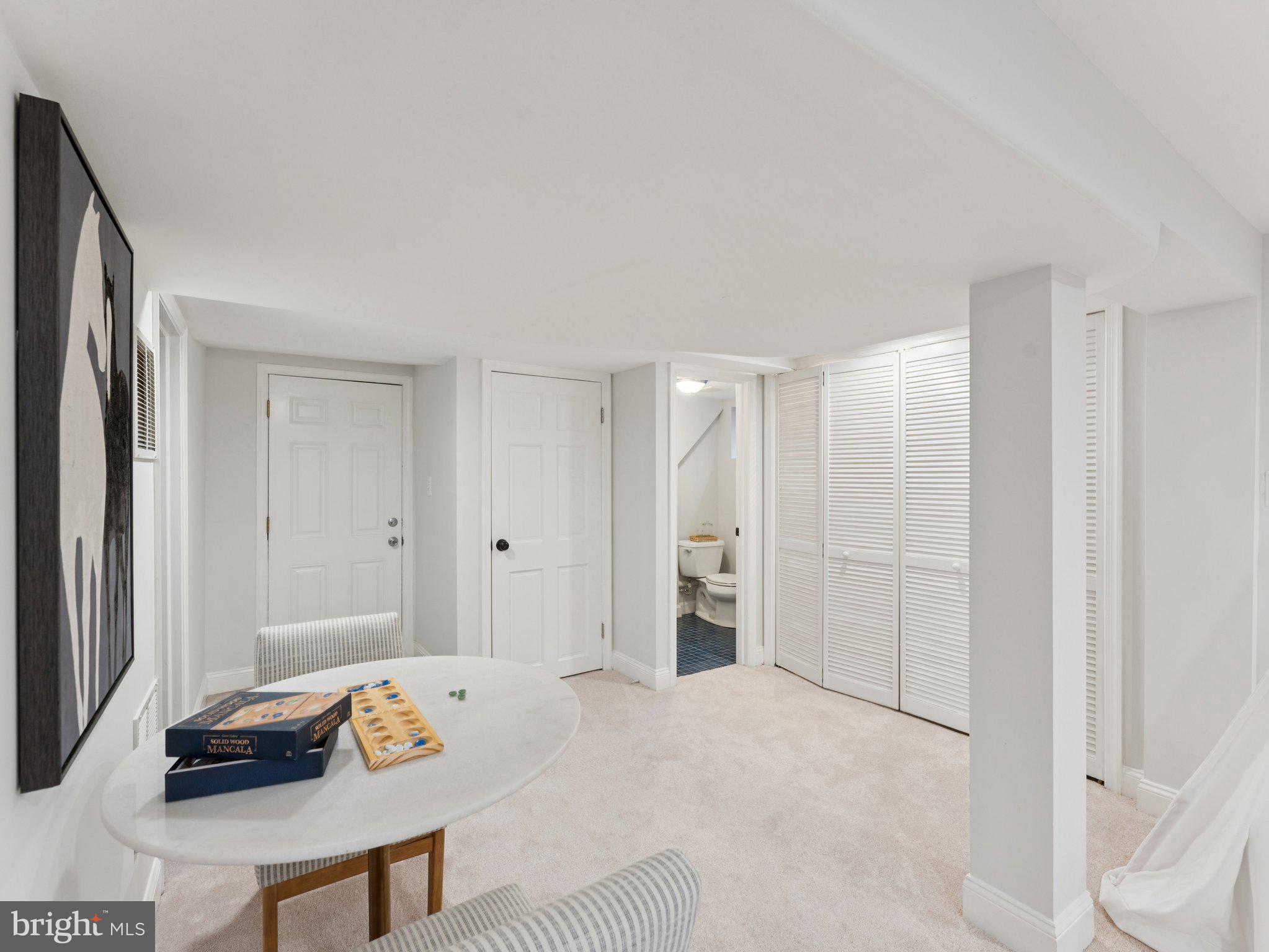 4821 45th Street Northwest Washington, DC 20016 - Photo 31 of 38 a spacious bedroom with a bed and a table in it