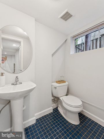 a bathroom with a sink toilet and a mirror