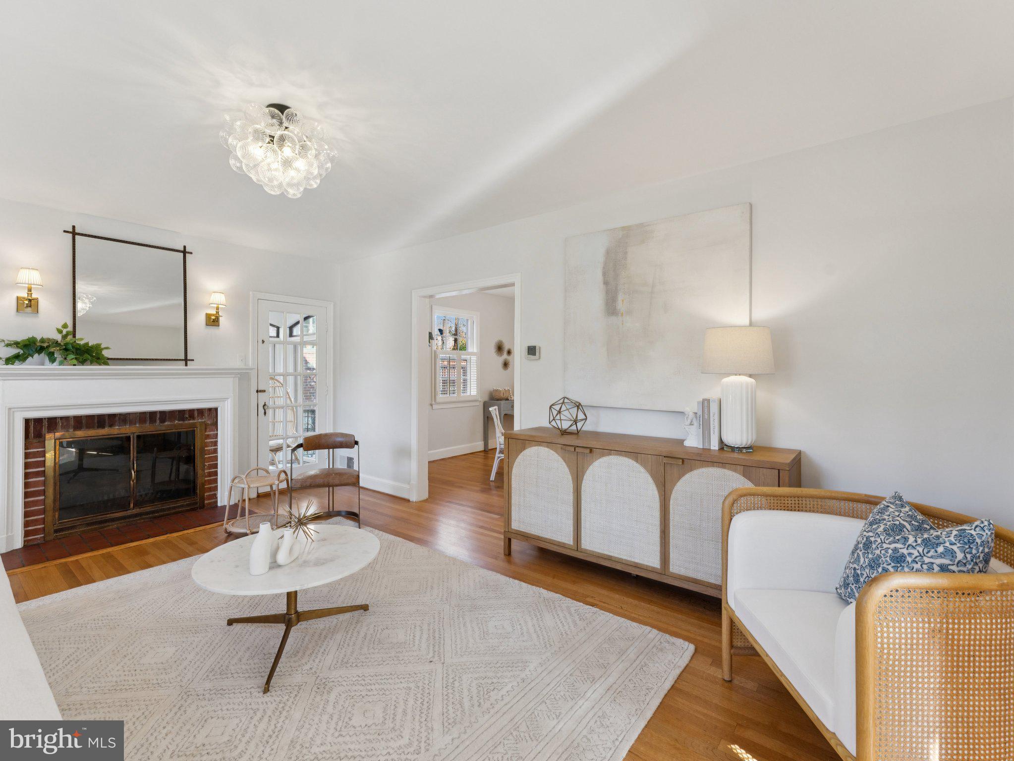4821 45th Street Northwest Washington, DC 20016 - Photo 4 of 38 a living room with furniture a fireplace and a chandelier
