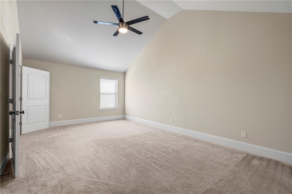 12 Juno Street Fort Mitchell, AL 36856 - Photo 33 of 43 Unfurnished room with high vaulted ceiling, carpet flooring, and a ceiling fan