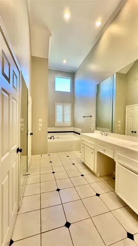 a large white kitchen with a large window