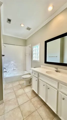 a bathroom with a granite countertop sink a toilet and a mirror
