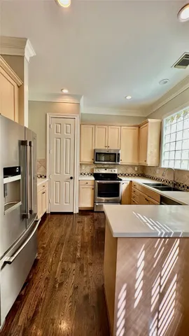 a kitchen with stainless steel appliances granite countertop a stove a sink and a refrigerator