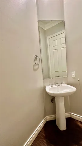a bathroom with a sink a toilet and mirror