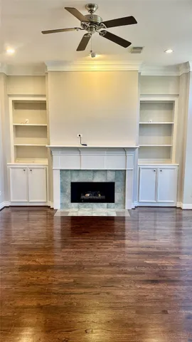 a view of a room with wooden floor and a fireplace
