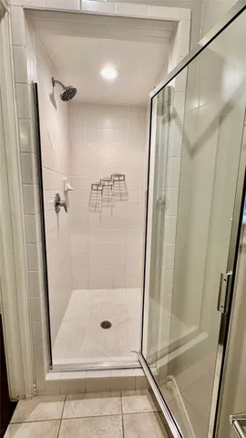 a bathroom with a glass door shower and toilet