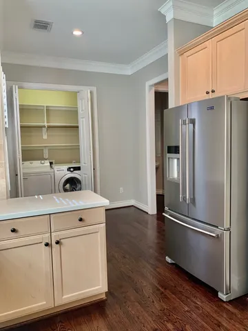 a kitchen with stainless steel appliances a refrigerator and cabinets