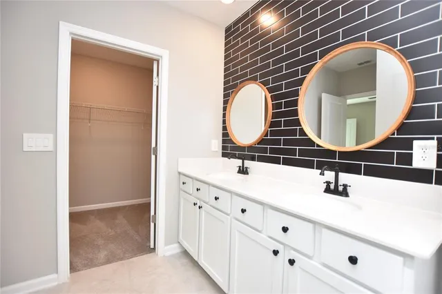 a bathroom with a double vanity sink and mirror