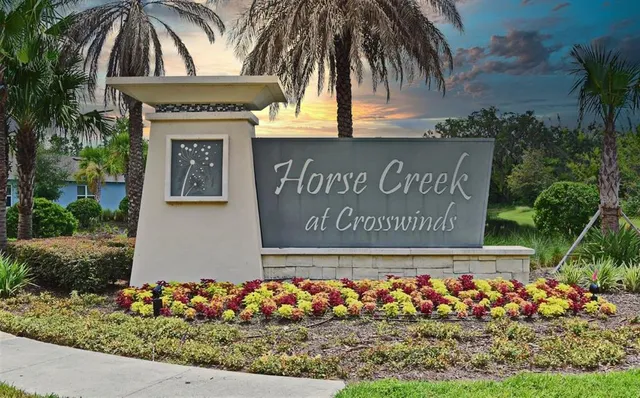 a view of sign board with potted plants