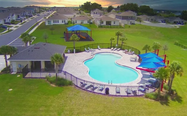 an aerial view of a house with outdoor space pool patio and lake view