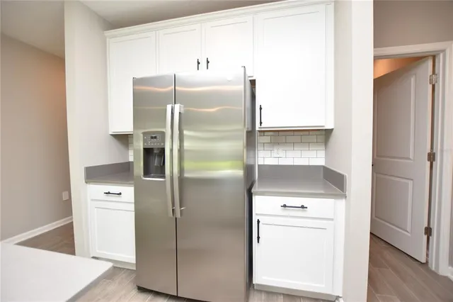 a kitchen with a refrigerator a stove a washer and dryer