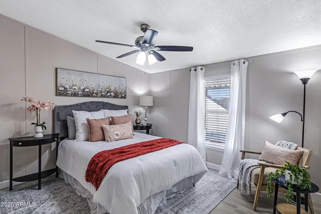 a bedroom with a bed and a chandelier