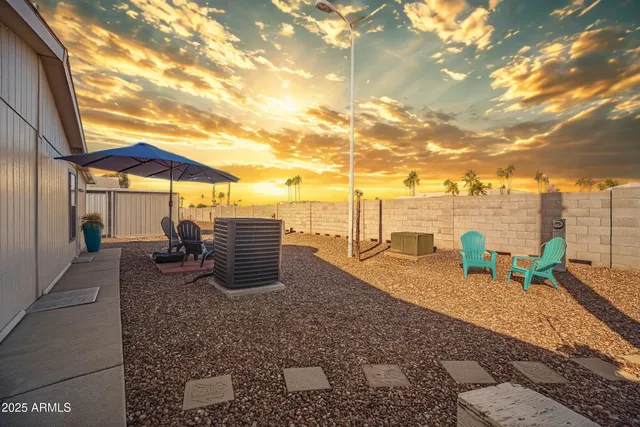 a view of a house with a yard and table