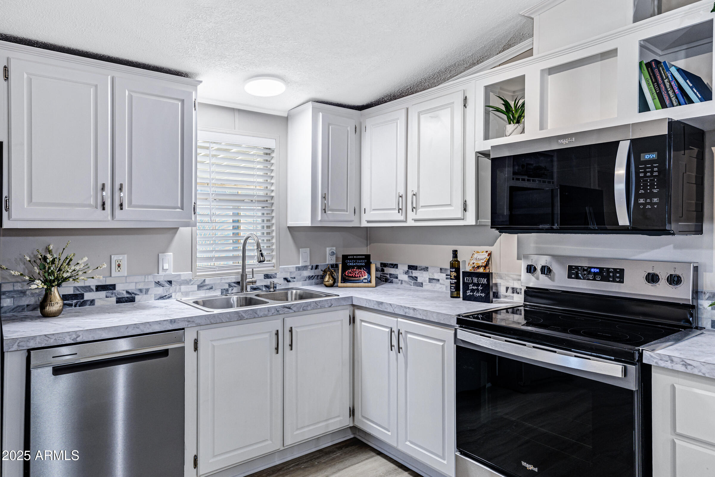 834 South Meridian Road, Unit 81 Apache Junction, AZ 85120 - Photo 4 of 22 a kitchen with stainless steel appliances a stove a microwave sink and cabinets