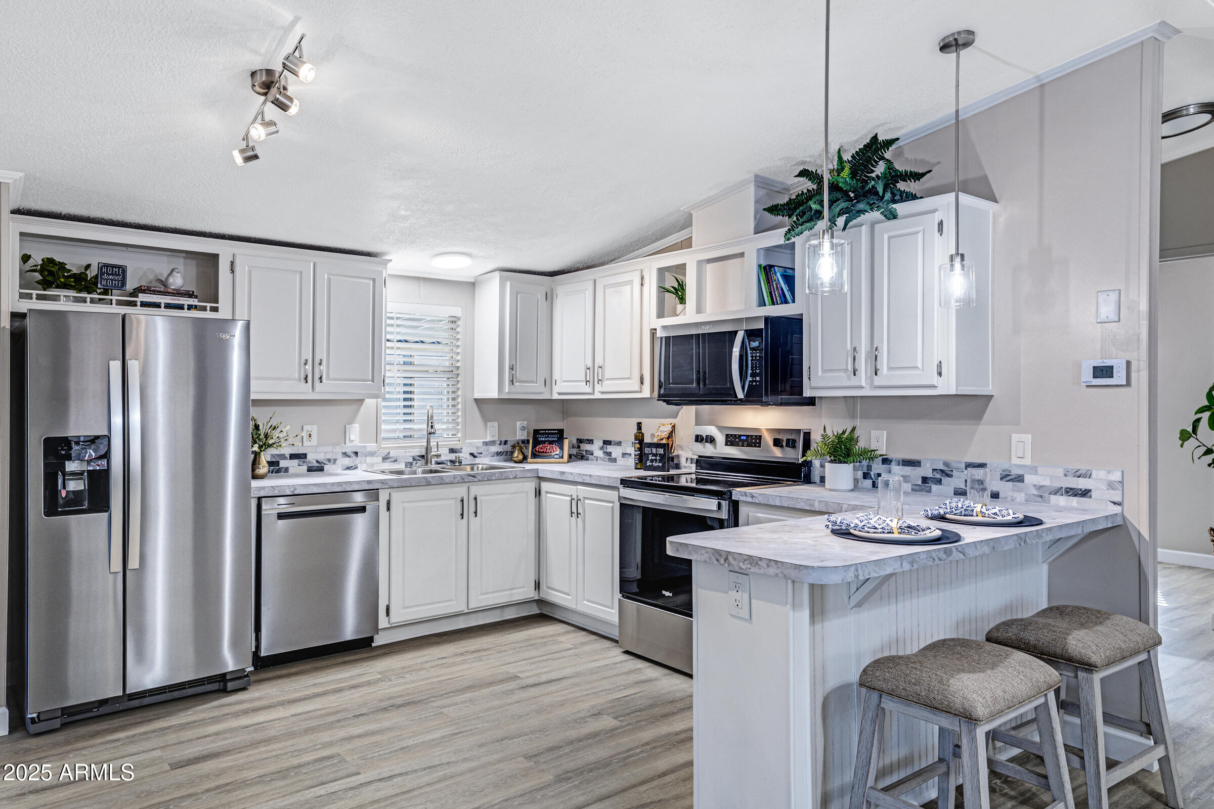 834 South Meridian Road, Unit 81 Apache Junction, AZ 85120 - Photo 5 of 22 a kitchen with appliances a sink and cabinets