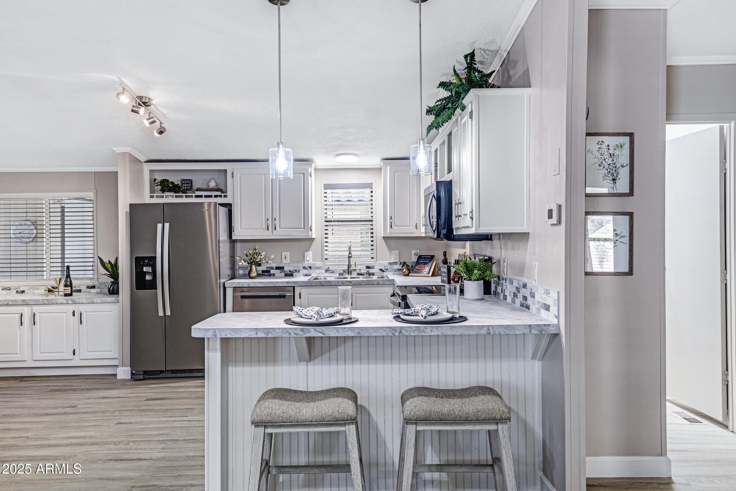 834 South Meridian Road, Unit 81 Apache Junction, AZ 85120 - Photo 6 of 22 a kitchen with stainless steel appliances granite countertop a table chairs refrigerator and sink