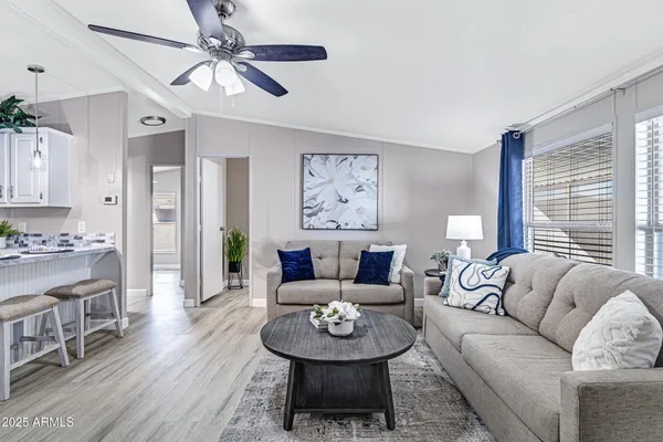 a living room with furniture a rug and a window