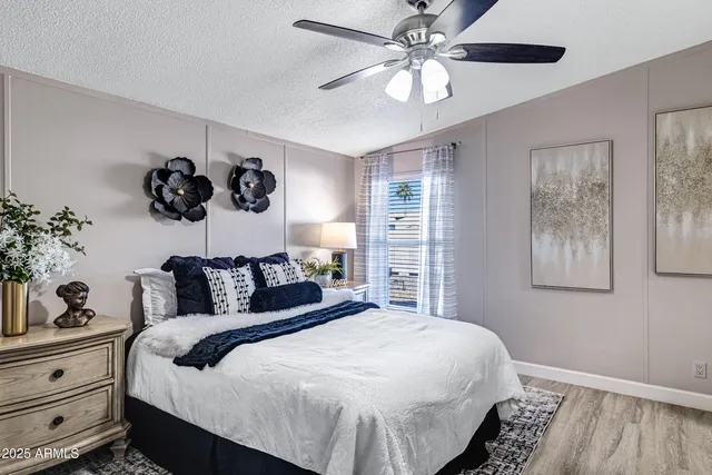 a bedroom with a large bed and a chandelier
